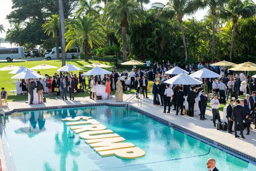 Coin Club members gathered beside the pool